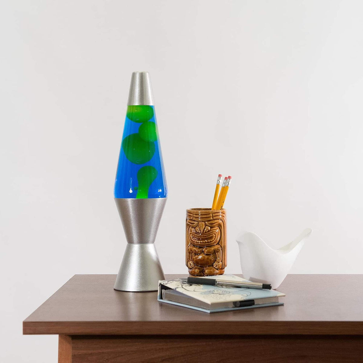 14.5” Lamp – Yellow/Blue/Silver on a table with a notebook and tiki mug pencil cup