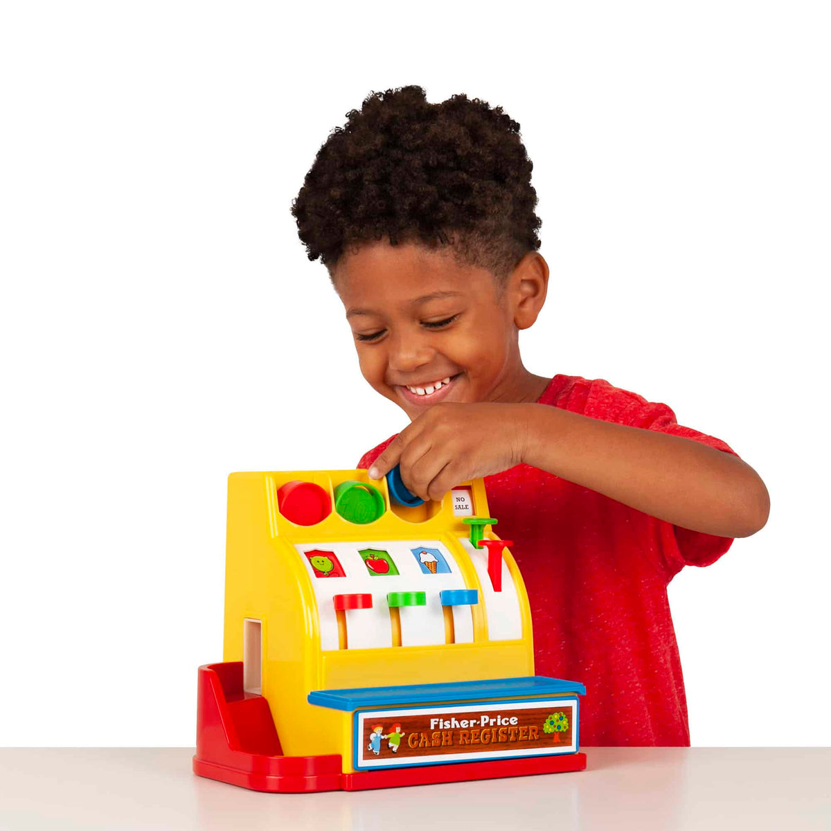 Lifestyle shot of boy putting coins in the Cash Register