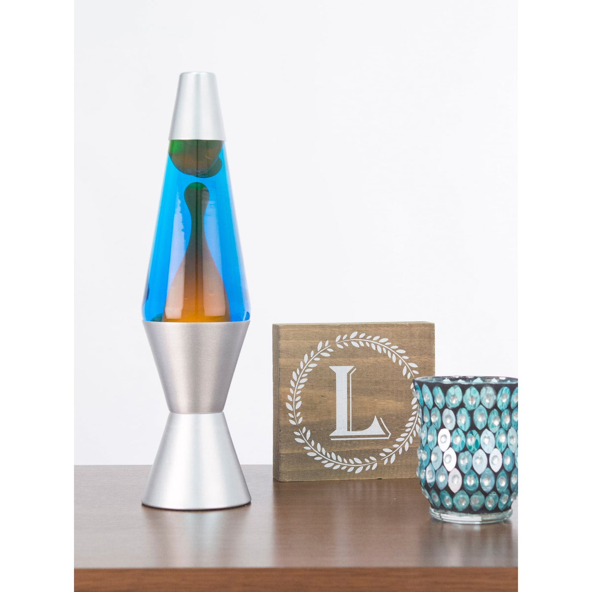 14.5” Lamp – Orange/Blue/Silver on shelf with candle and sign