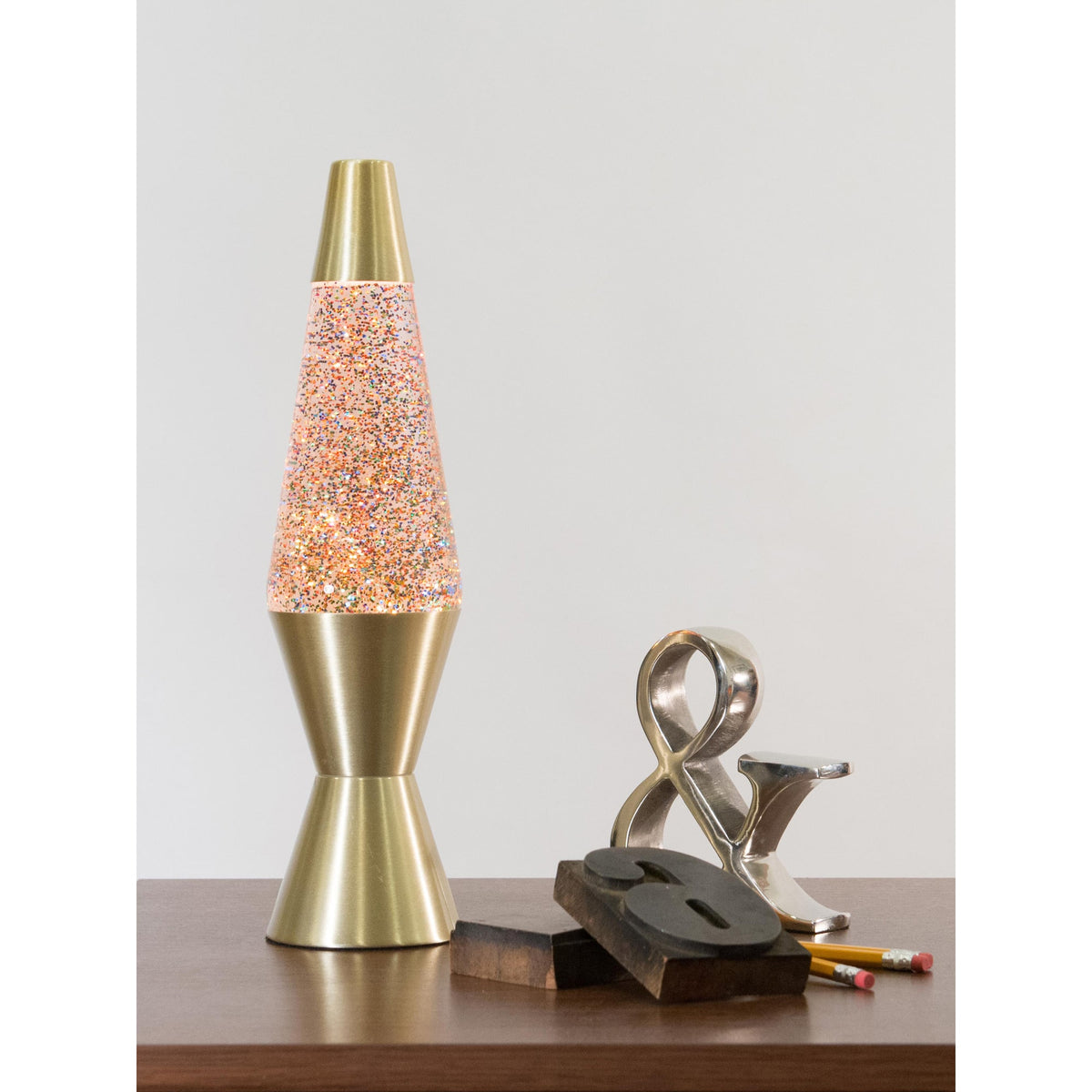 14.5” Lamp Rainbow Glitter – Clear/Gold on a table with knick knacks