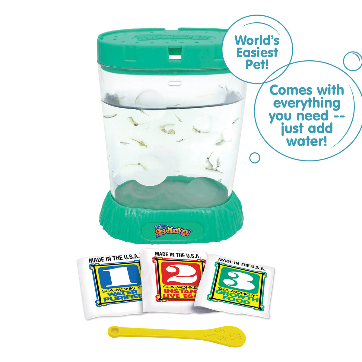 A teal aquarium is filled with water and . Laying in front, there are three packets, numbered 1, 2, and 3 from left to right. There is a small yellow spoon laying in front of the packets. There are two callouts in circles. One reads "World's Easiest Pet!" and the other reads "Comes with everything you need - just add water!"