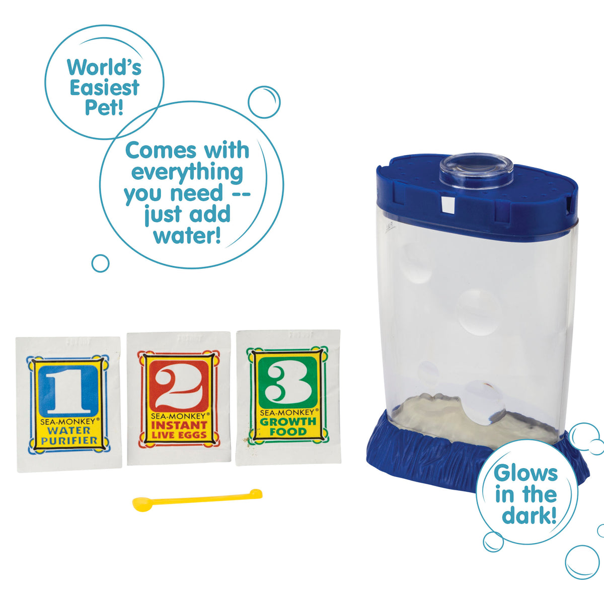 Three packets, numbered 1, 2, and 3 from left to right are vivble next to a blue Magiquarium. There is a small yellow spoon laying in front of the packets. There are three callouts in circles. They read "World's Easiest Pet!", "Comes with everything you need - just add water!", and "Glows in the dark!"