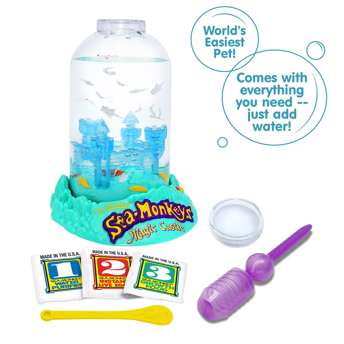 Three packets, numbered 1, 2, and 3 from left to right are vivble in front of the Magic Castle aquarium. There is a small yellow spoon laying in front of the packets, and a purple pipette and clear circle magnifyer next to the spoon. There are two callouts in circles. They read "World's Easiest Pet!", and "Comes with everything you need -- just add water!"