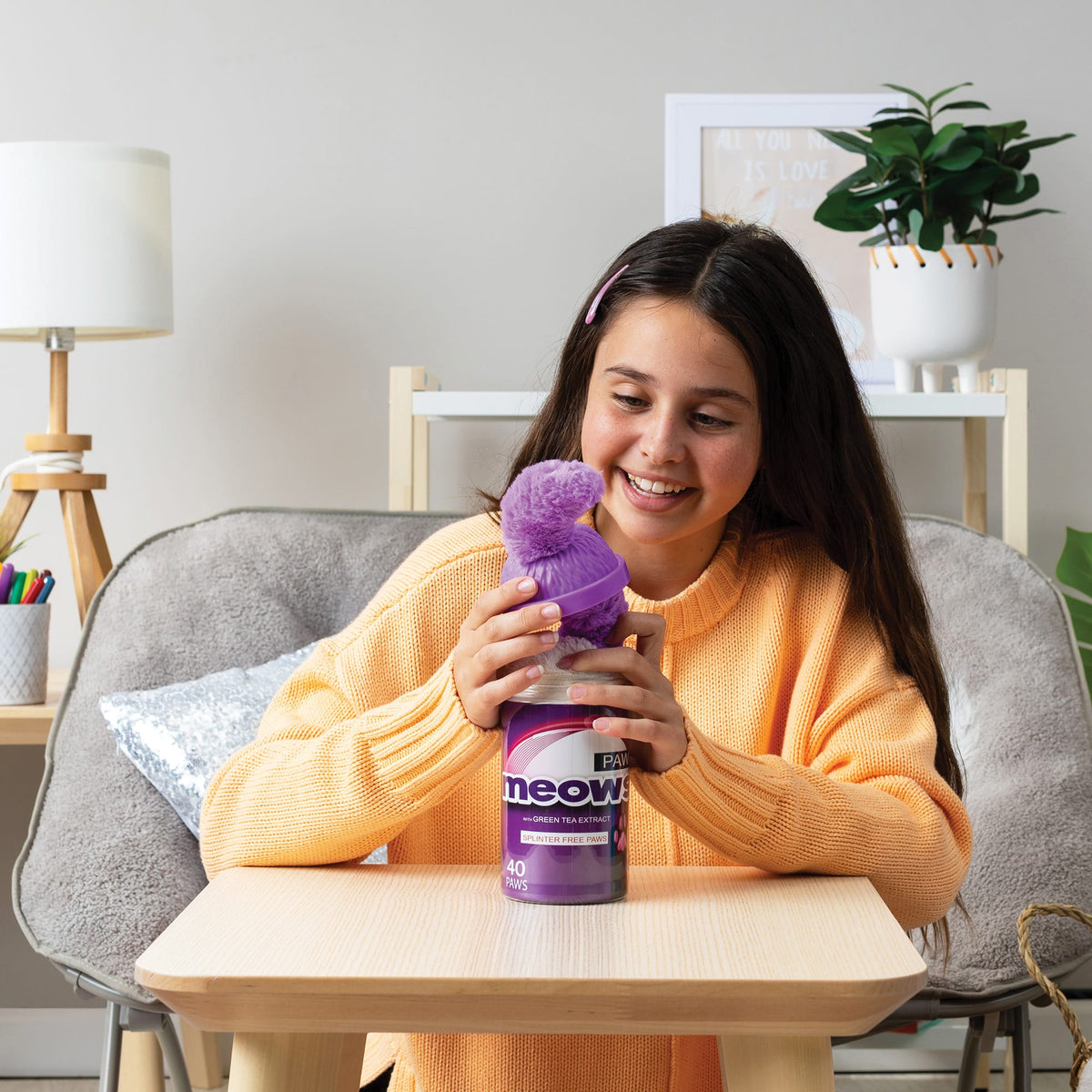 Girl opening the top of a purple package