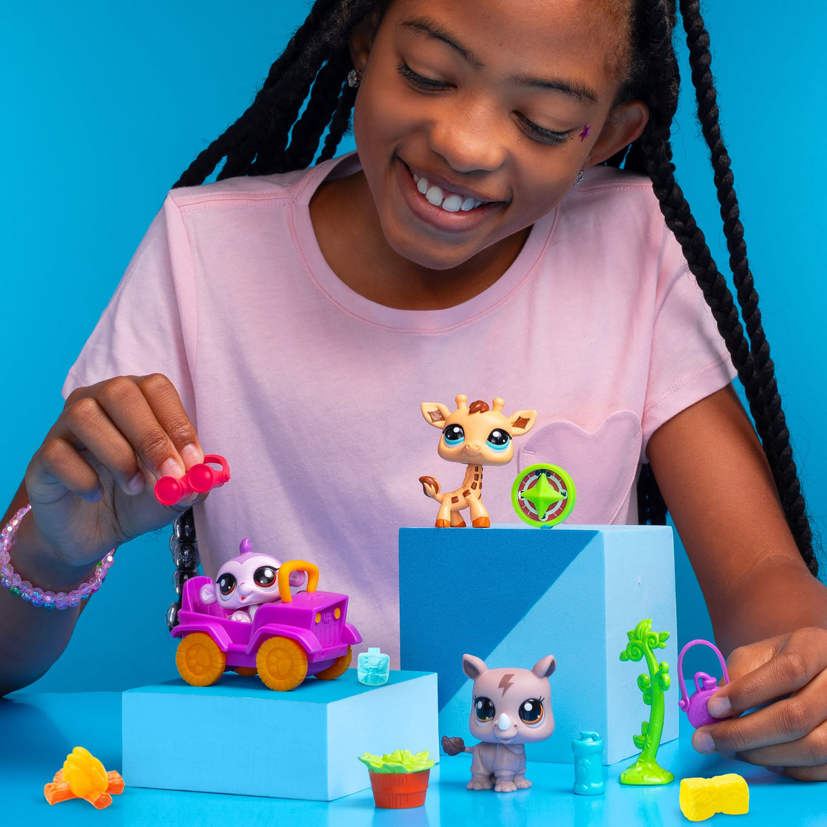 Safari Play Pack - Lifestyle shot of girl playing with 3 animals and accessories