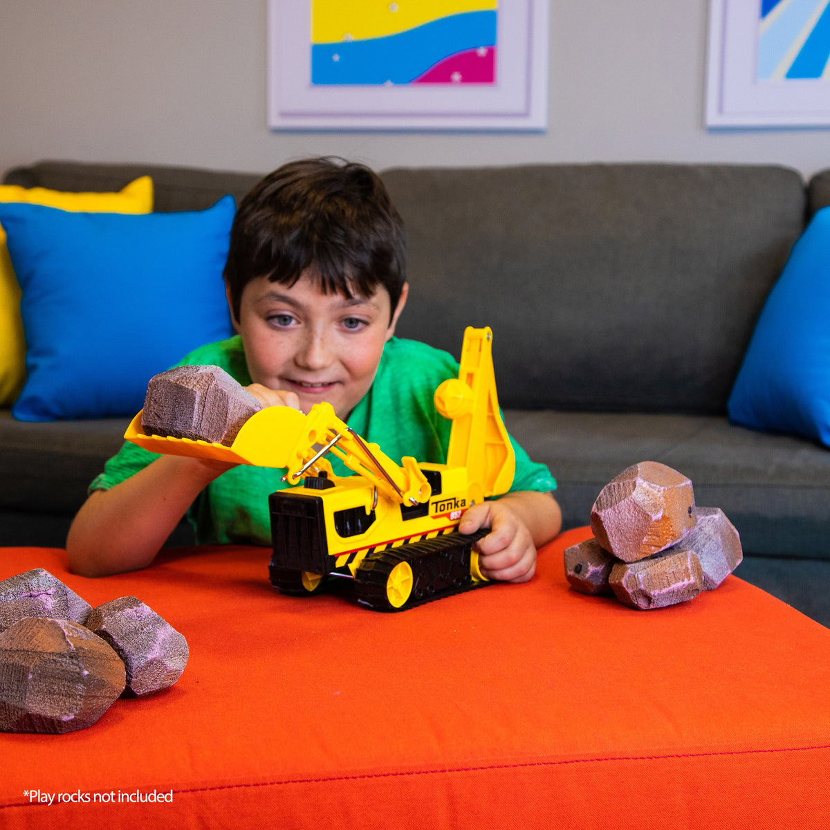 Trencher - Boy in Living Room lifting play rocks