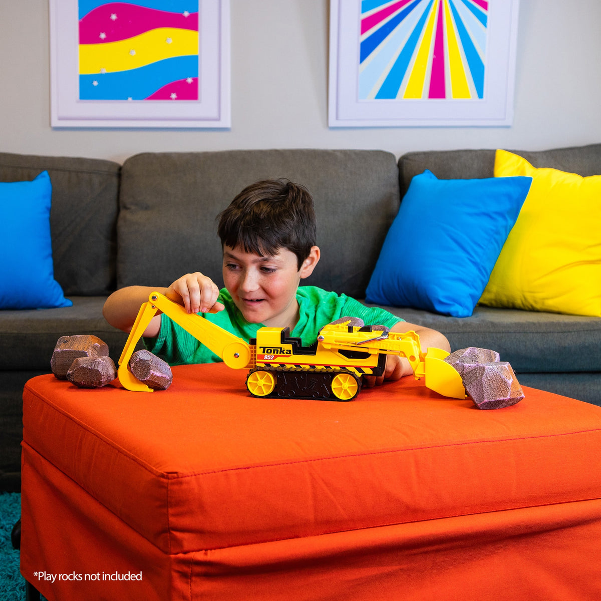 Trencher - Boy in Living Room scooping play rocks